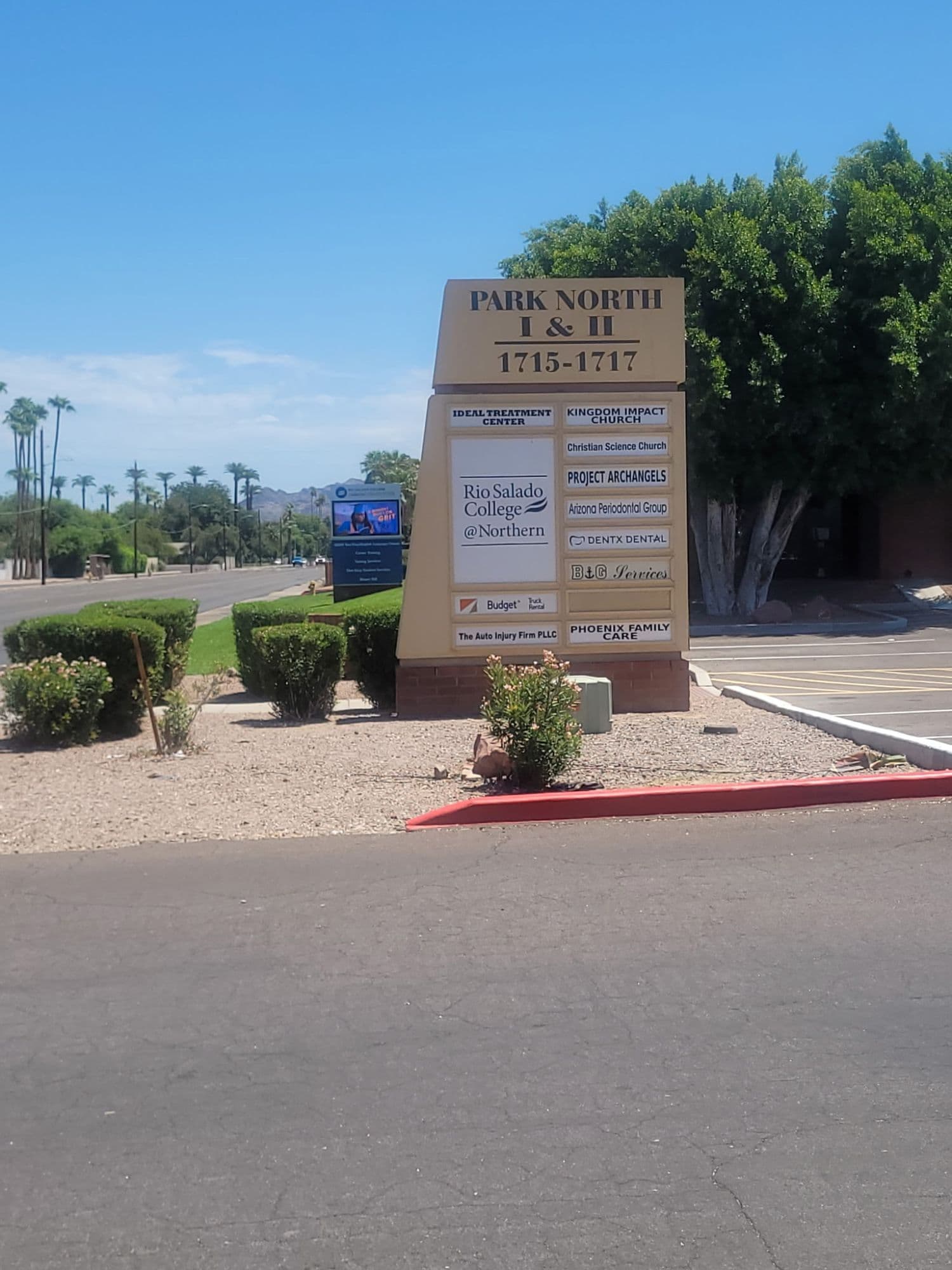 The Park North I & II monument sign seen from W Northern Avenue, with the clinic building behind it
